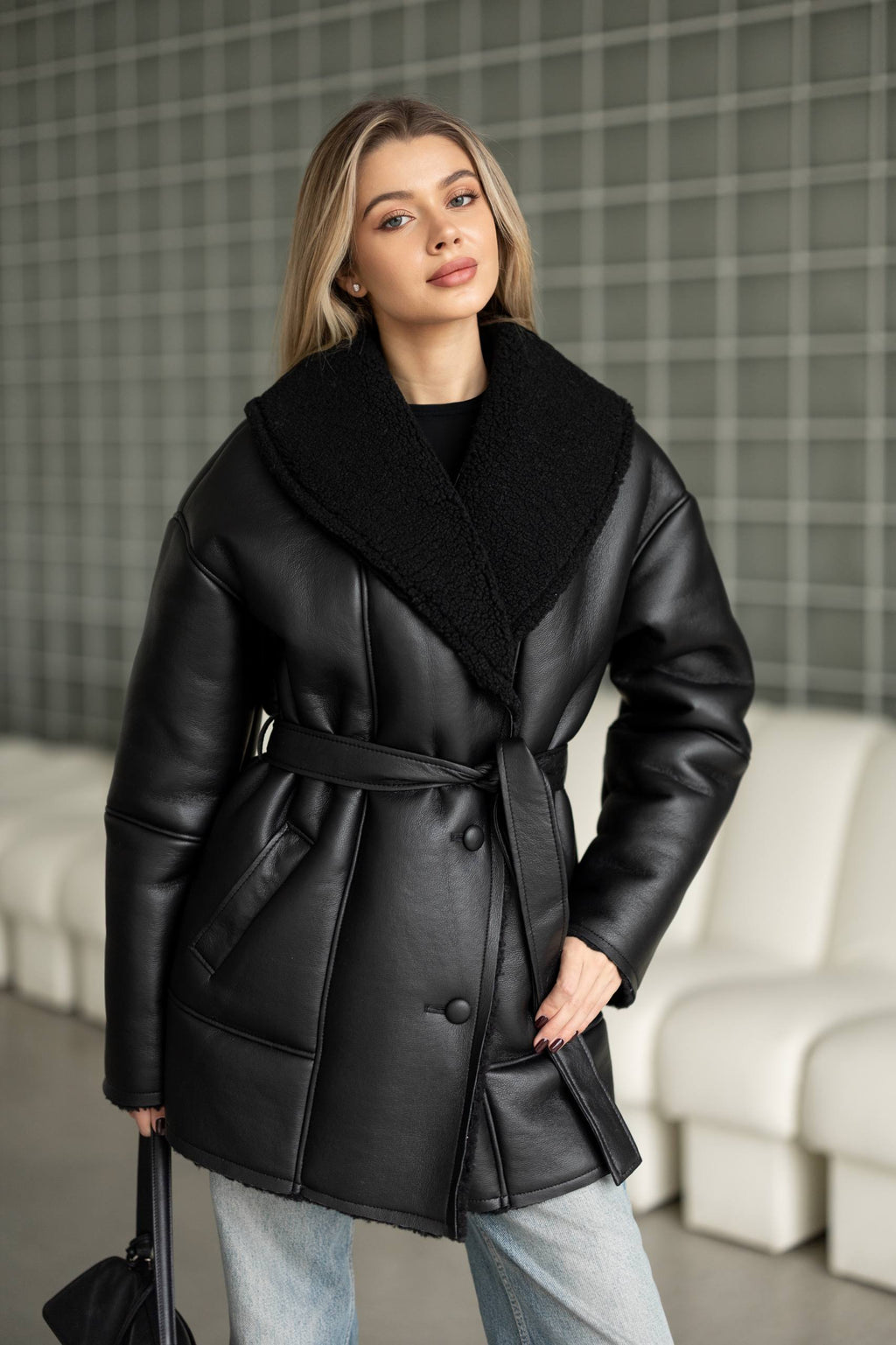 Elongated eco-leather shearling coat with teddy fur and a belt included