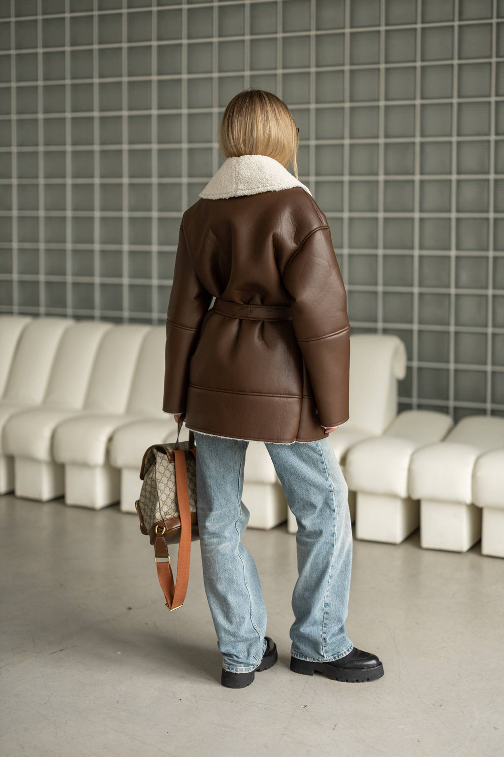 Elongated eco-leather shearling coat with teddy fur and a belt included