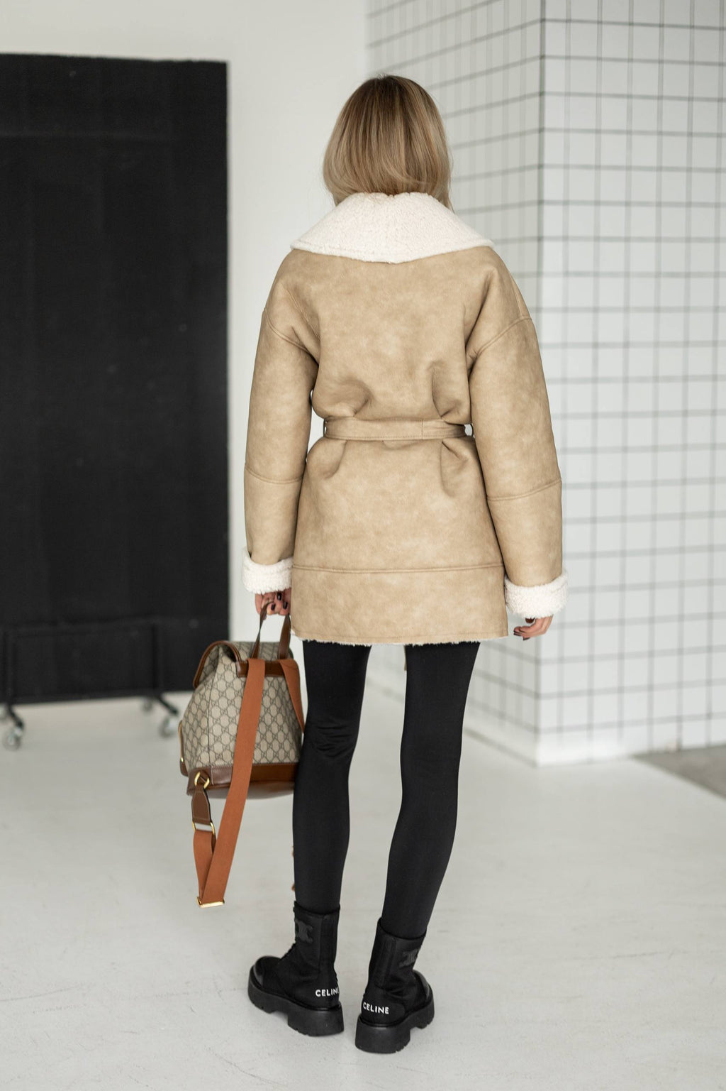 Elongated eco-leather shearling coat with teddy fur and a belt included