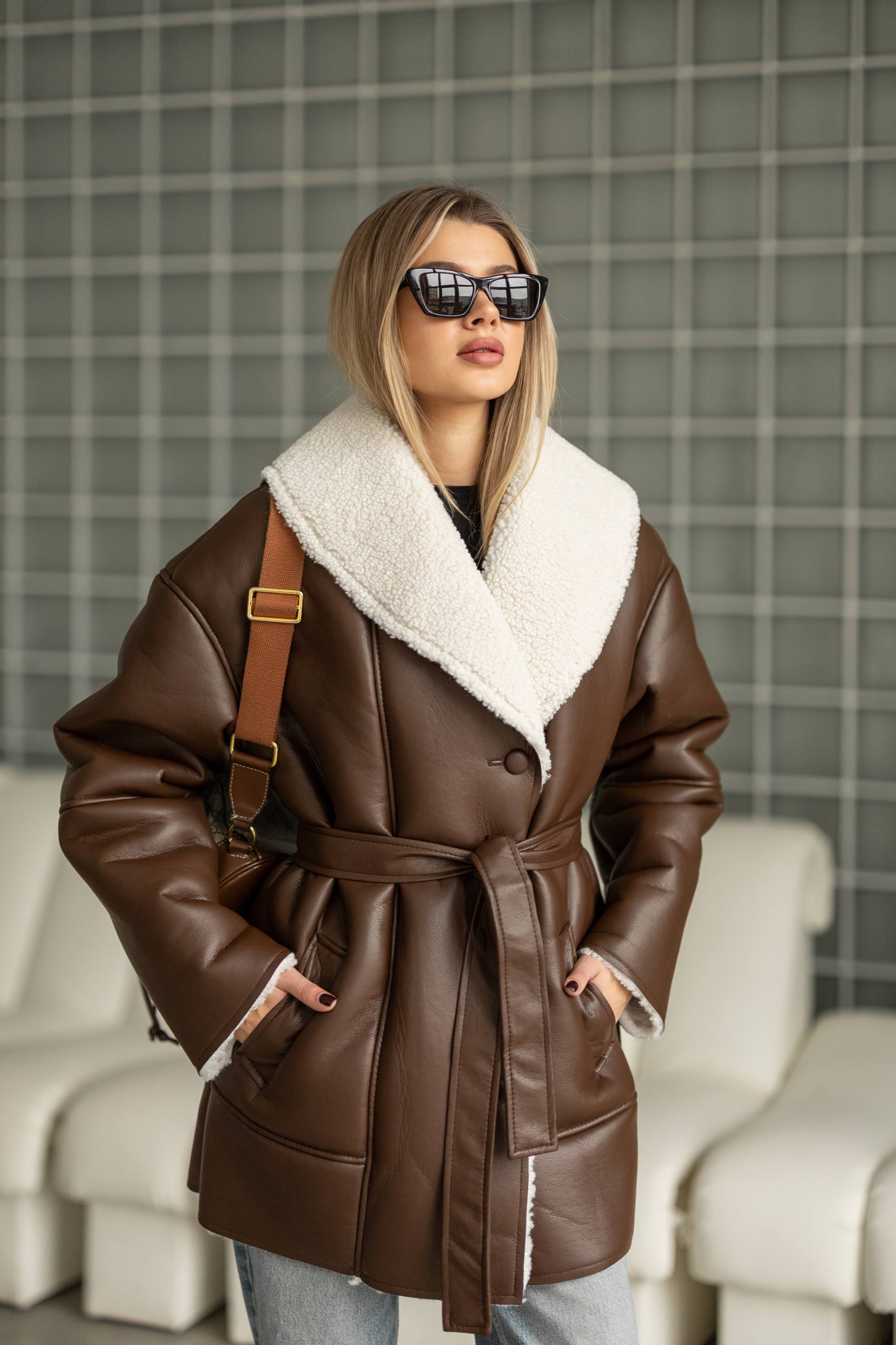 Elongated eco-leather shearling coat with teddy fur and a belt included