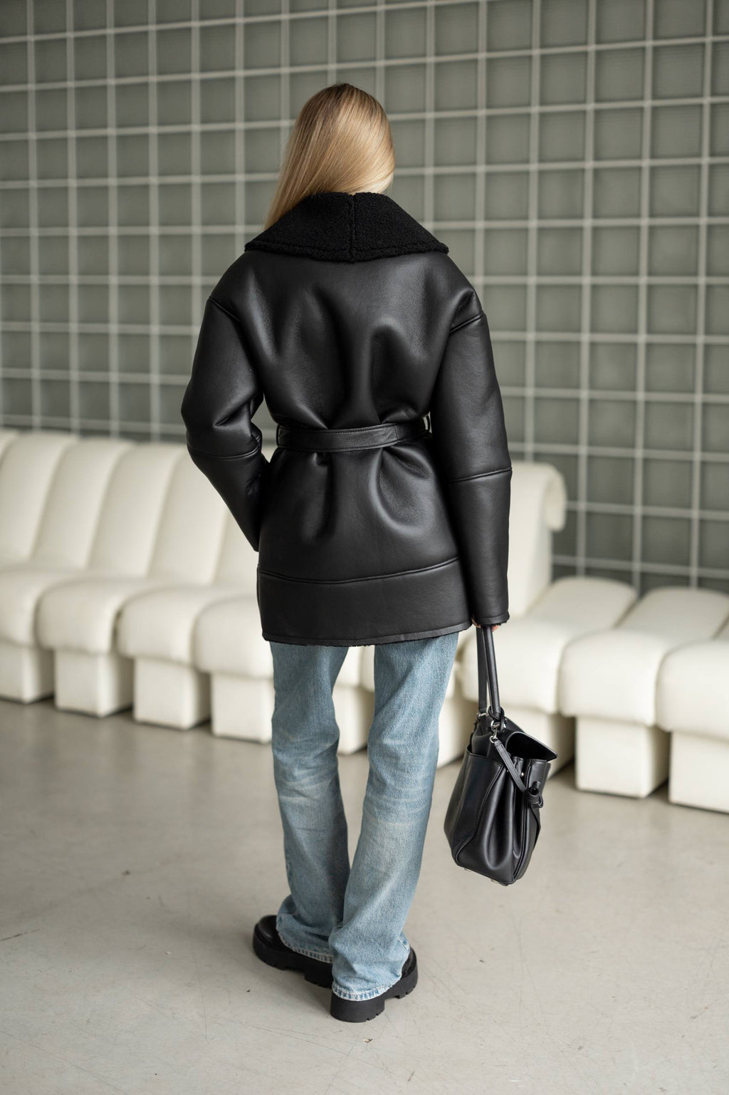 Elongated eco-leather shearling coat with teddy fur and a belt included